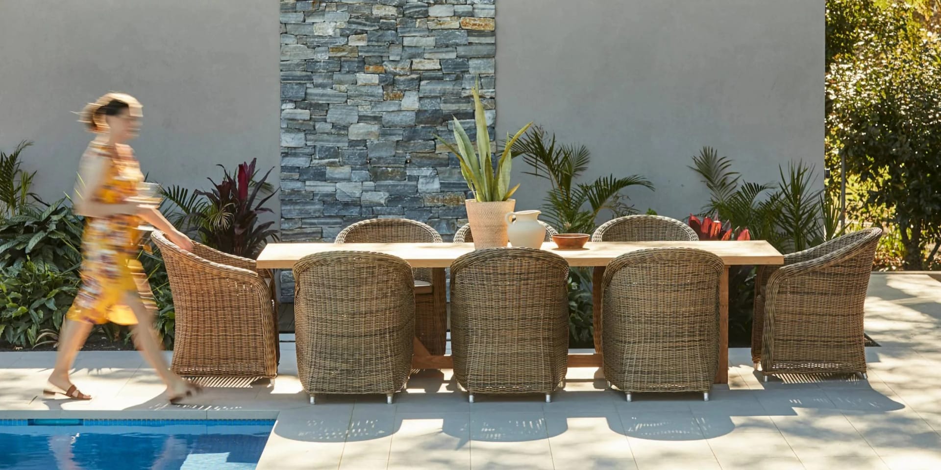 Handwoven rattan lounge set on a golden-hour veranda